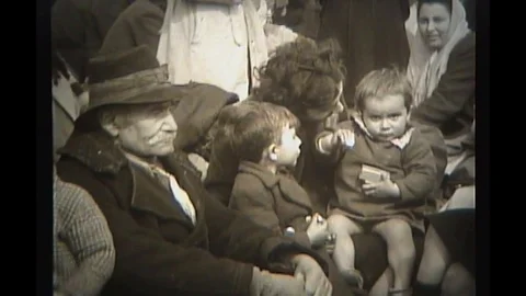 1944 - As they wait for processing, Italian refugees comfort their children. Stock Footage 101700220