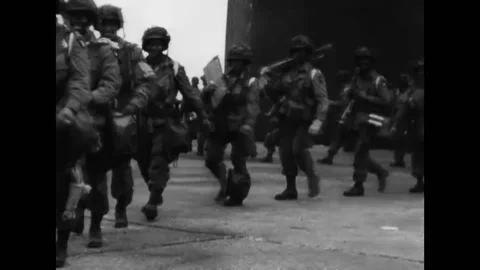 1944 - US Army Air Force paratroopers don their gear and reread their orders for Stock Footage 159146700