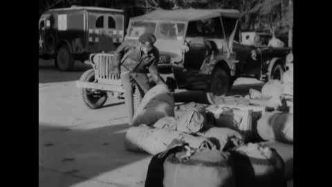 1944 - US Army Air Force airmen load their gear onto trucks and drive out. Stock Footage 205601084