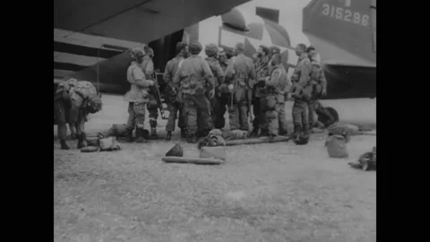 1944 - US Army Air Force paratroopers gather their gear and board their plane. Stock Footage 241669219