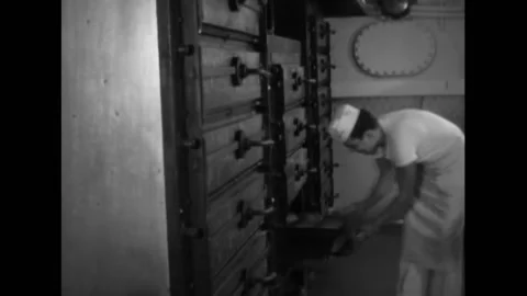 1944 - US Navy bakers take loaves of bread out of the oven on the USS Stock Footage 173397460
