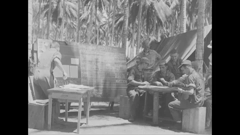 1944 - A USAF reconnaissance pilot, stationed in Guadalcanal, gets briefed on Stock Footage 100599566