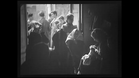 1944 - While waiting for their Red Cross designation, Italian refugees knit. Stock Footage 102176042