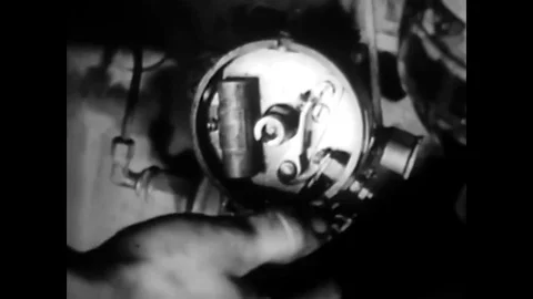 1945 - The breaker point resistance and automotive coils are checked. Stock Footage