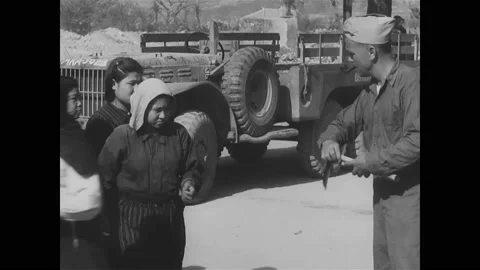 1945 - Farming tools are distributed to Japanese women at a US Military Vídeo Stock 226470276