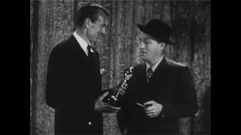 1945 - Gary Cooper presents Bing Crosby with the Best Actor Oscar for "Going My Stock Footage 246358516