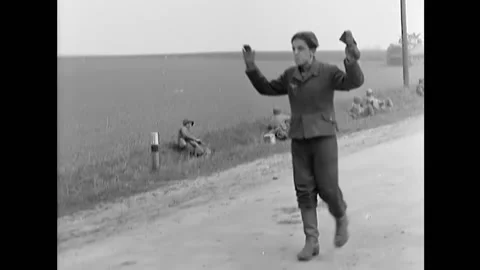 1945 - German POWs surrender to American soldiers, and they carry one of their 스톡 동영상 164530482