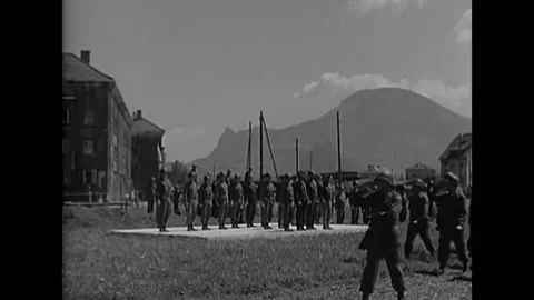 1945 - Troops of the 1109th combat group march during a visit by Secretary of Video stock 232892607