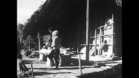 1945 - US Army doctors perform a quick operation to remove shrapnel from a young Stock Footage 170505095
