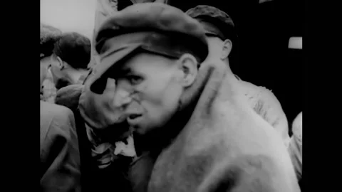 1945 - US Army medics load Holocaust victims onto ambulances, while others wait Stock Footage 166840812