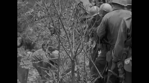 1945 - US Army medics remove a wounded soldier from an Okinawa battlefield, Stock Footage 168877755