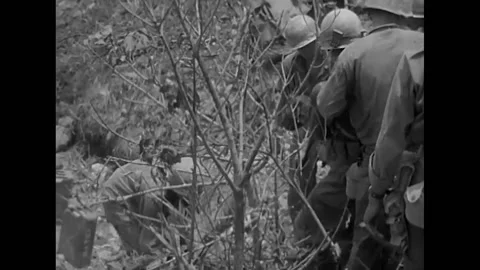 1945 - US Army medics remove a wounded soldier on a litter on Okinawa, and pass 스톡 동영상 203778392