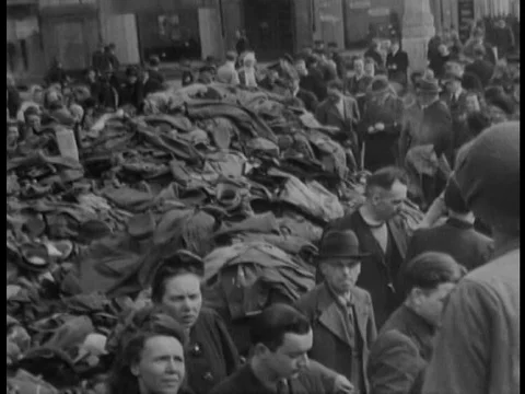1945 WW2 newsreel shows street crowds with massive piles of surrendered German Stock Footage