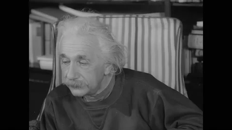 1946 - Albert Einstein listens intently at a meeting of America's Committee on Stock Footage 166831341