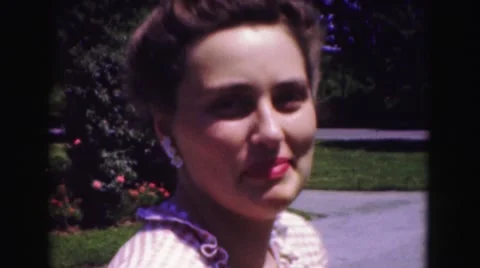 1946: beautiful well dressed woman standing outdoor in garden WASHINGTON, DC Stock Footage