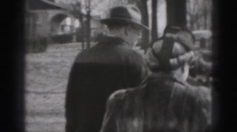 1946: early 20th century man and woman pack car wearing fur coats HARRISBURG Stock Footage