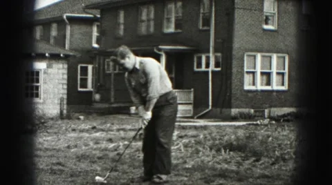 1946: hitting the ball the golf player walks away throwing his golf club Stock Footage