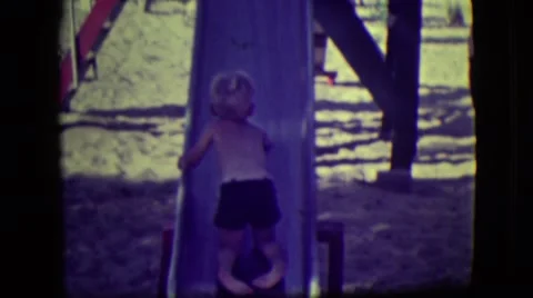 1946: kids playing on slides in a park LAS VEGAS, NEVADA Stock Footage