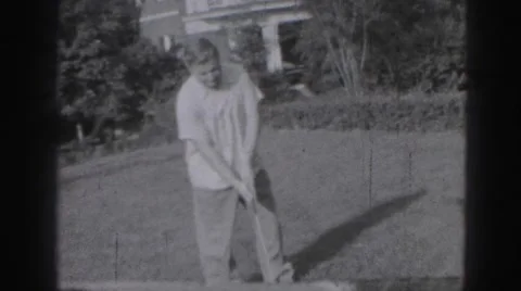 1946: man is seen beside garden playing HARRISBURG Stock Footage
