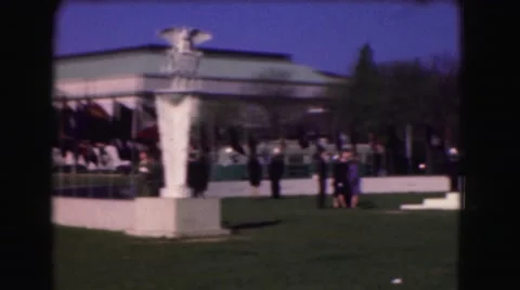 1946: people gathered at military memorial event on windy day walking Stock Footage