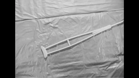 1947 - Parallel bars help a paralyzed veteran prep for doing exercises with his Stock Footage 119018946