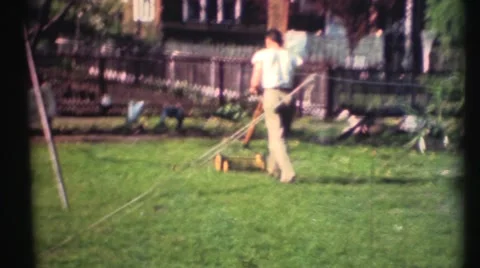 1948  ,Dad mowing the lawn with push mower Stock Footage 55573646