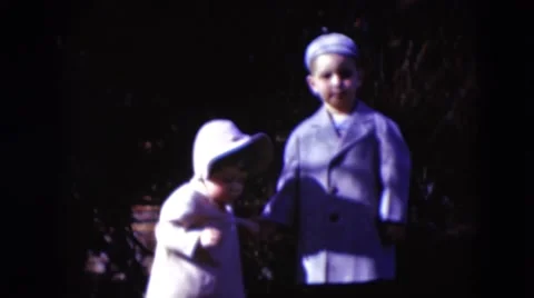 1949: boy playing with sister in school uniforms bonnets for girls MIDDLETOWN Stock Footage
