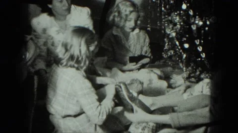 1949: caucasian family ravenously opening xmas gifts VENICE, ITALY Stock Footage
