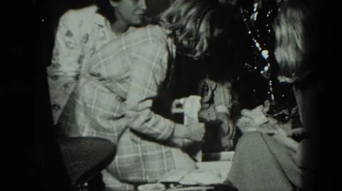 1949: girl open confusing christmas present in her robe VENICE, ITALY Stock Footage