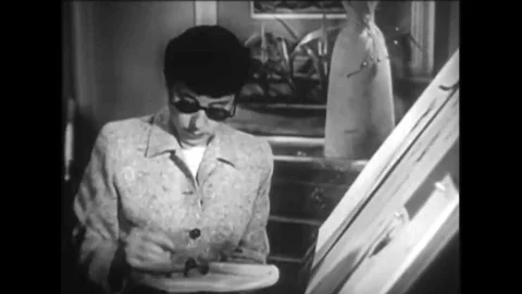 1950 - Edith Head works on some rough costume sketches, then has a producer sign Stock Footage 143781582