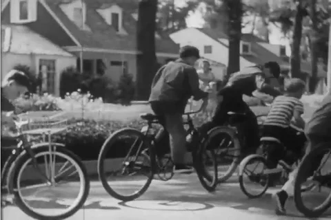 1950 - A little boy tries to keep up on foot when his big brother goes out Vídeos de archivo 99403069