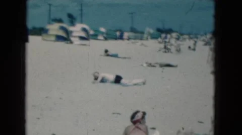 1950: An Old White Man Sunbathing on the Sandy Shore of a Florida Beach Stock Footage 68188490