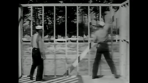 1950 - Sailors install wind bracing in a wall during the construction of a Stock Footage 79447684