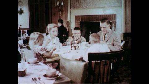 1950s-1960s : A family converses as it eats dessert at a restaurant. Stock Footage