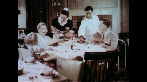 1950s-1960s : A waitress takes the orders of a family at a restaurant. Stock Footage