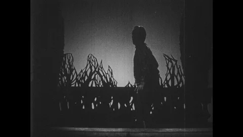 1950s: Actor performs Shakespeare play on stage. Printed script of Shakespeare's Stock Footage 128006695