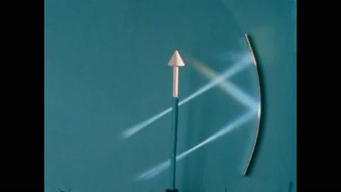 1950s: Arrow on a stand with two light beams reflecting from a concave mirror in Video stock 219633373