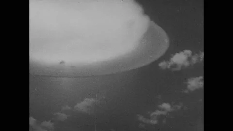 1950s: Atomic bomb explodes. Mushroom cloud. Bombers in sky. 動画素材 159168782
