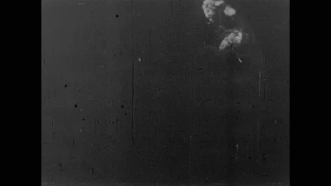 1950s: Atomic bomb explodes near buildings in desert. Houses in desert burn and Stock Footage 159101985