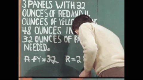 1950s: boy paints math problem with equations on wall, hand paints "R=2Y" on Vídeos de archivo 172031013