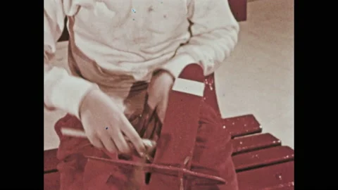 1950s: boy points to stripes on toy plane wings, plays with rubber band, shoots Stock Footage 147405276