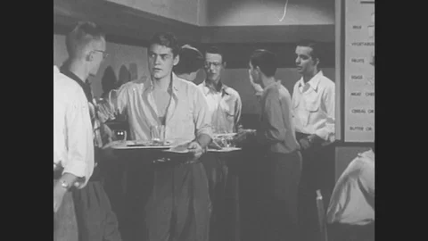 1950s: Boys in line in cafeteria, boy tries to cut in line. Stock Footage