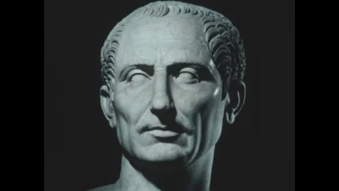 1950s: Bust of Julius Caesar. Man in a toga sprawled on tiles. Statue of Emperor Stock Footage 295375113