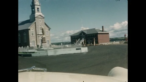 1950s: CANADA AND UNITED STATES: church building by river. Ladies walk near Stock Footage
