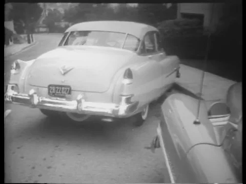 1950s car pulls out of parallel parking space master Stock-Footage 81909261