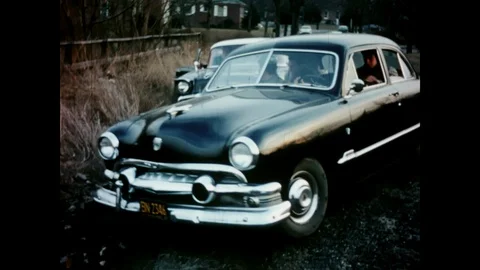 1950s car pulls over and men get out and fight, vintage archival Stock Footage 125836562