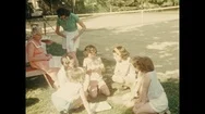 1950S: Children And Adults Sit Together.  Little Girl Opens Presents.  Woman Stock Footage