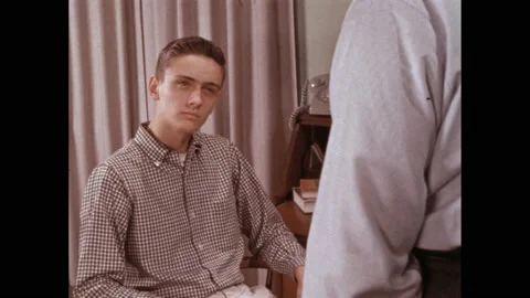 1950s: clapper board in front of young actor’s face. Boy speaks with father at Stock Footage 219965378