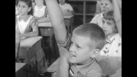 1950s: close up of all children raising their hands / children lower their hands Stock-Footage