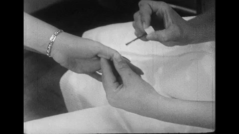 1950s: Close up, hand getting manicure / Barber turns man in chair, show hair in Stock Footage 74560599